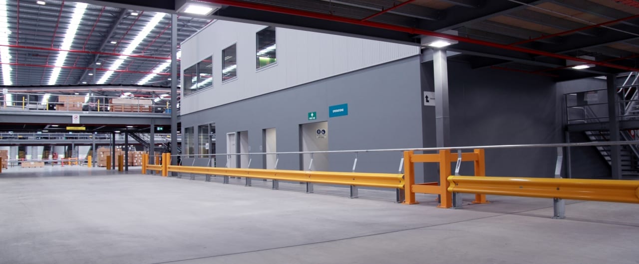 RHINO-STOP® Warehouse Guardrail rhino stop safety barrier inside a warehouse