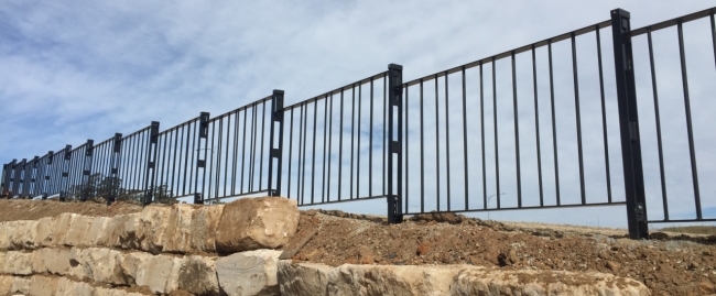 pedestrian fencing installation to restrict pedestrian access to the detention basins